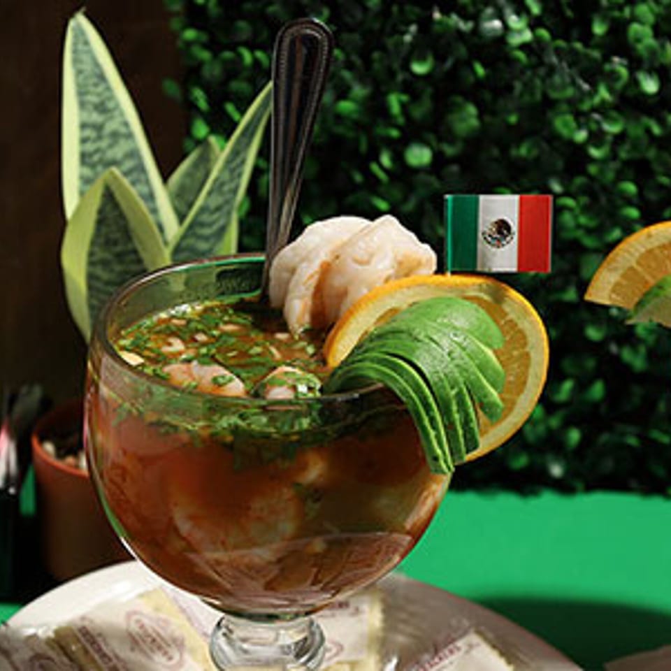 Frida's Mexican Restaurant's shrimp cocktail with avocado, orange, and a Mexican flag pick.